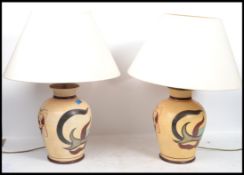 A pair of matching 20th century studio pottery table lamps by Red Mud Lighting. The lamps both