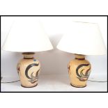 A pair of matching 20th century studio pottery table lamps by Red Mud Lighting. The lamps both