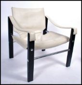 A mid 20th Century Maurice Burke Arkana safari chair / armchair. Upholstered in  faux white