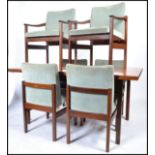 A 1970's believed Heals of London teak wood dining table and 6 chairs - suite. Raised on squared