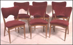 A set of Danish mid century 1950's  dining chairs in the manner of AJ Milne. Raised on shaped legs