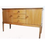 An original mid century Gordon Russell walnut sideboard / dresser. Raised on squared legs with a