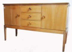 An original mid century Gordon Russell walnut sideboard / dresser. Raised on squared legs with a