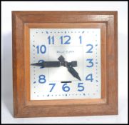 A vintage early 20th century French Art Deco Bulle Electrique Oak Wall Clock, with 15 1/2 in. square