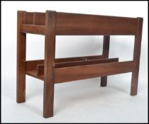 A 1970's Danish teak wood retro magazine rack - Canterbury by Guy Rogers. The panelled body with