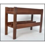 A 1970's Danish teak wood retro magazine rack - Canterbury by Guy Rogers. The panelled body with