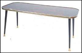A vintage retro 20th century coffee table raised on tapering ebonised legs having a geometric design