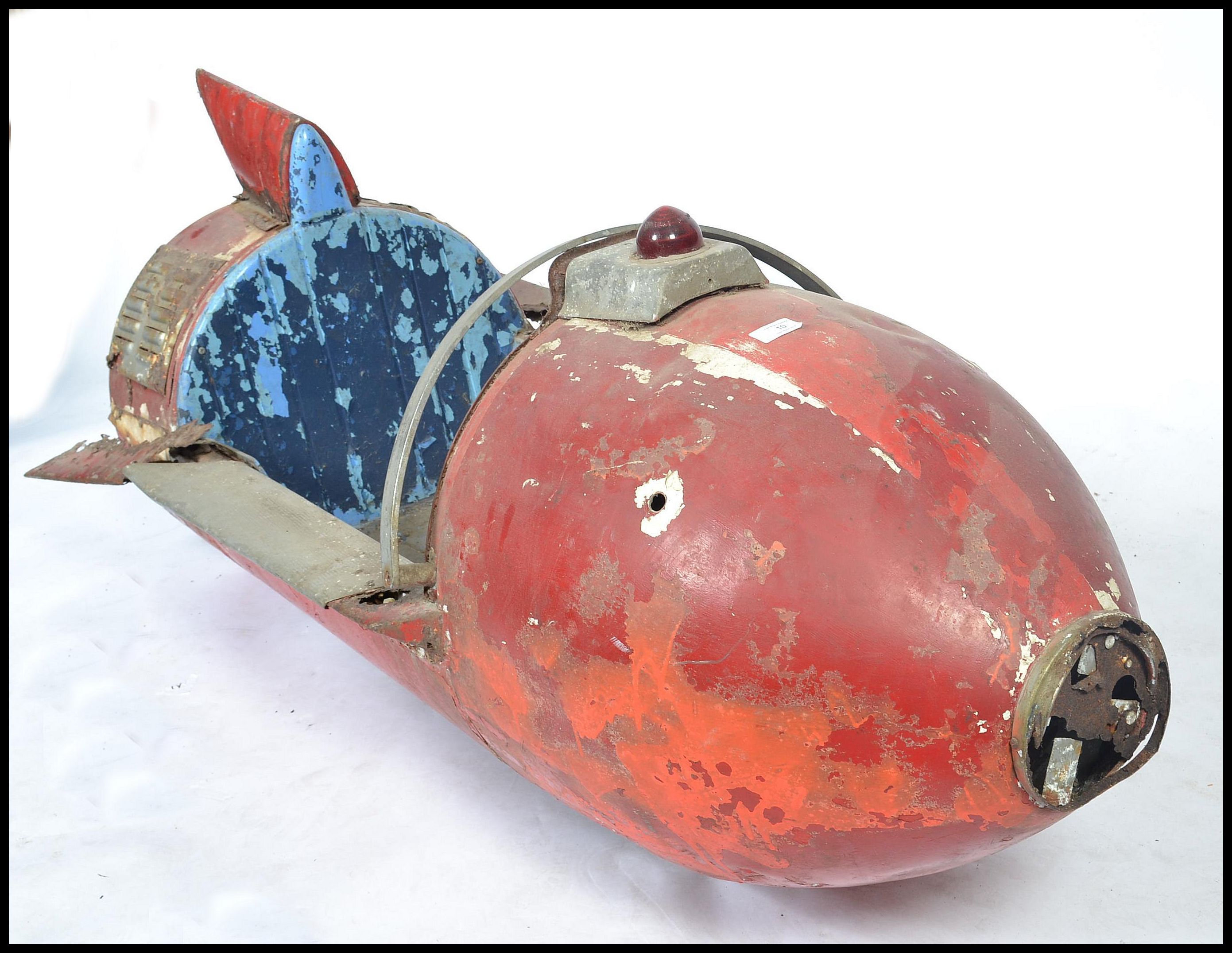 A mid century original fairground carousel ride spaceship rocket. The rocket with remains of