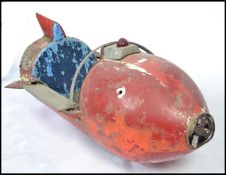 A mid century original fairground carousel ride spaceship rocket. The rocket with remains of