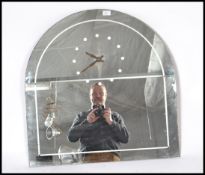 A 1930's Art Deco mirror clock. The mirror of arched form with original inset clock to the centre,