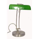A 20th century retro bankers lamp having a brushed metal twin sweeping arm attached to a terraced