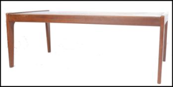A 1970's teak wood Komfort Danish large coffee - occasional table being raised on tapering leg