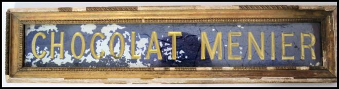 An early 20th century glass shop sign for ' Chocolat Menier ' The rectangular sign with gilded