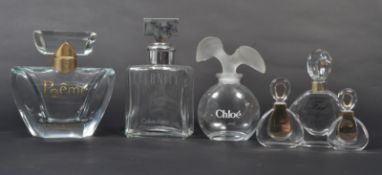 A group of vintage 20th century advertising point of sale shop display perfume bottles to include