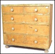 A Victorian distressed pine 2 over 3 chest of drawers having scrumbled finish remains of paint all