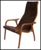 A 20th century Yngve Ekstrom beech framed lamino easy chair - armchair with woollen upholstery.