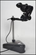 A vintage mid century opticians eye glass magnifier lamp by Cooke & Yorke. Ebonised with weighted