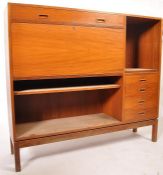 A 1970's teak wood Danish influence high board sideboard raised on squared legs with a bank of