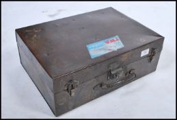 A retro 20th century polished metal suitcase having clasps to the front with handle and travel label