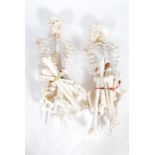 A pair 20th century full size resin / composite doctors hospital medical study skeleton of the human