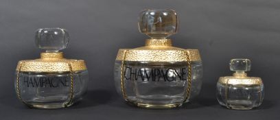 A graduating set of three vintage 20th century Yves Saint Laurent Champagne 1993 advertising point