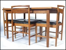 A 1970's McIntosh  rectangular teak wood dining table and chairs. The extending teak dining table