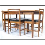 A 1970's McIntosh  rectangular teak wood dining table and chairs. The extending teak dining table