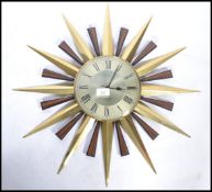 A vintage 20th century Metamec sun burst star burst wall clock having a Roman numeral chapter ring