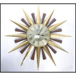 A vintage 20th century Metamec sun burst star burst wall clock having a Roman numeral chapter ring