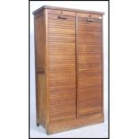 A good early 20th century oak Industrial tambour fronted tall narrow teak tambour front French