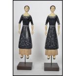A pair of interesting American Gothic wooden dolls. Each of a lady with period dress and costume
