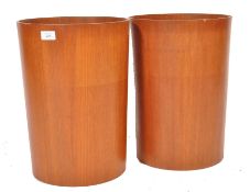 A pair of 1960's mid century retro teak wood cylinder waste paper bin / bins being stamped to the