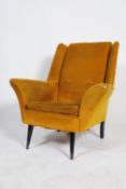 A mid century retro vintage wing back armchair in a striking yellow corduroy upholstery with two