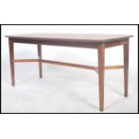 A 1960's mid century teak wood coffee table raised on tapering legs with an x-frame stretcher,