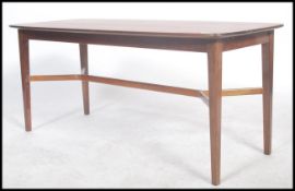 A 1960's mid century teak wood coffee table raised on tapering legs with an x-frame stretcher,