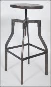 A vintage 20th century machinists chair stool. Raised on tubular metal frame with lower foot