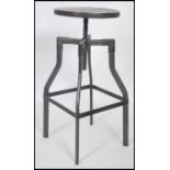 A vintage 20th century machinists chair stool. Raised on tubular metal frame with lower foot