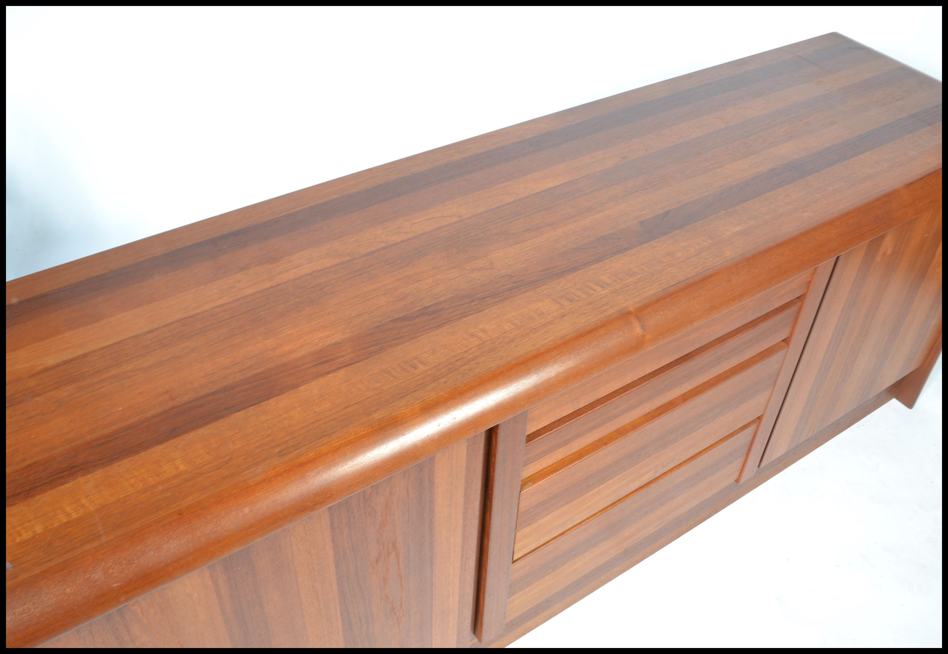 A 20th century Danish sideboard of low form and heavy solid teak construction by Ejvind Johansen - Image 3 of 7