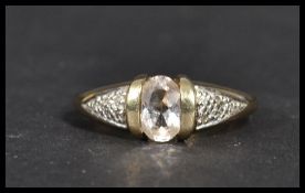 A hallmarked 9 carat gold ring with an oval clear