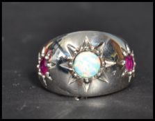 A sterling silver opal and ruby dress ring. The th