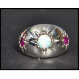 A sterling silver opal and ruby dress ring. The th