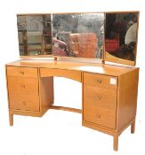 A mid century retro dressing table chest by John &