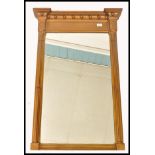 A 19th century Regency gilt painted overmantel mirror of rectangular upright form. Column sides with