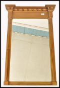 A 19th century Regency gilt painted overmantel mirror of rectangular upright form. Column sides with