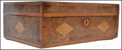 A 19th century Victorian walnut work box having a marquetry top with inset diamond shaped burr maple