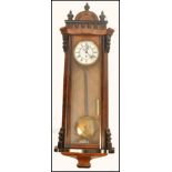 A 19th century Vienna Regulator wall single train clock having a walnut and ebonised case with