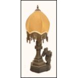 An early 20th century spelter Chinoiserie lamp raised on a stepped hexagonal base with tapered