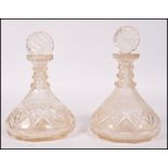 A pair of 19th century Georgian cut glass naval ships decanters. The flat bottomed bodies having