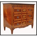 A 20th century French parquetry inlaid chest of drawers. Raised on squared legs with a series of