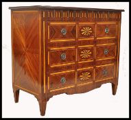 A 20th century French parquetry inlaid chest of drawers. Raised on squared legs with a series of